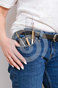 Woman pocket in jeans with pens and pensil