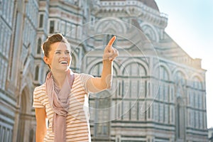 Woman pointing on copy space in florence, italy