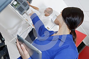 Woman pointing and giving instructions to senior colleague