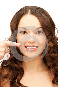 Woman pointing at her toothy smile