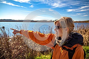 Woman pointing in Horicon Marsh, the largest freshwater cattail marsh in the United States