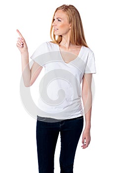 Woman pointing and looking at copyspace