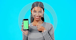 Woman, pointing and phone green screen mockup with a smile and hand for advertising website space. Face of indian female