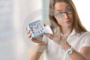 Woman pointing at time, focus on clock, deadline punctuality con photo