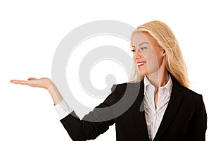 Woman pointing to cpoy space - holding arm as presenting a produ