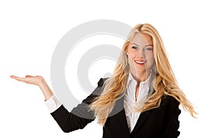woman pointing to cpoy space - holding arm as presenting a product