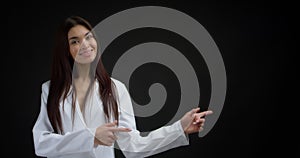 Woman pointing to an empty space for your advertising content.