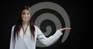 Woman pointing to an empty space for your advertising content.