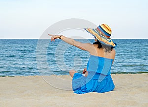 Woman pointing to the ocean