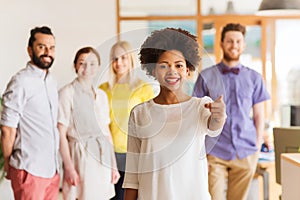 Woman pointing to you over creative office team