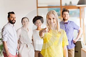 Woman pointing to you over creative office team