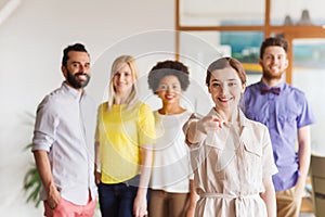 Woman pointing to you over creative office team