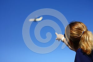 woman pointing towards the blue sky