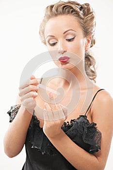 woman polishing fingernails