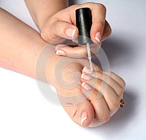 woman polishing fingernails
