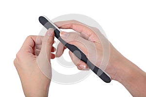 Woman polishing fingernails with nail file