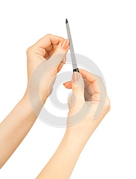 Woman polishing fingernails with nail file,