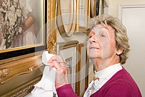 Woman polishing picture frames photo