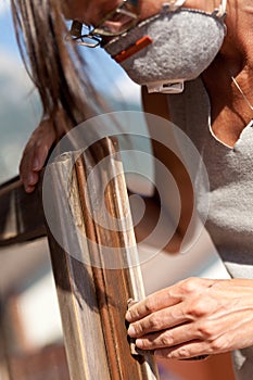 Woman polishing a window with sand