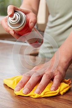 Woman Polishing Wooden Surface With Duster