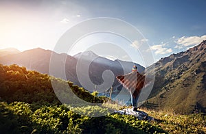 Woman in poncho at the mountains photo