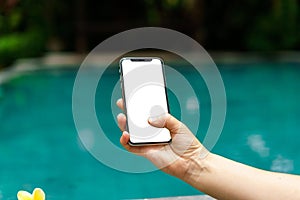 Woman in the pool holding phone with an screen and modern frame less design