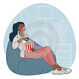 Woman with popcorn is watching TV