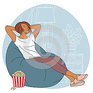 Woman with popcorn is watching TV