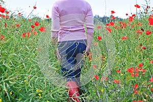 Woman in a poppy field