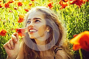 Woman in poppy flowers. pretty woman or happy girl in field of poppy seed