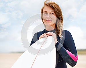 Woman in portrait, beach and surfboard, vacation and surfer on adventure for fitness and travel. Ocean, waves for