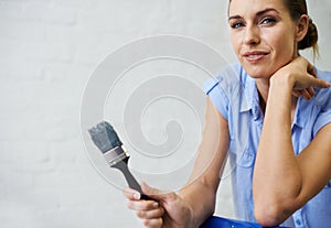 Woman, portrait and brush for painting in home, remodeling and maintenance in apartment. Female person, tenant and