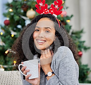 Woman, portrait and Christmas in home with coffee cup for winter break or festive season, tree or hot chocolate. Female