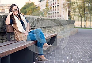 Woman portrait in the city sitted on banch