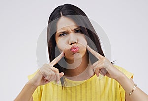 Woman, portrait and crazy in studio, lips and comic or funny expression on grey background. Comedian, mouth or cheeks