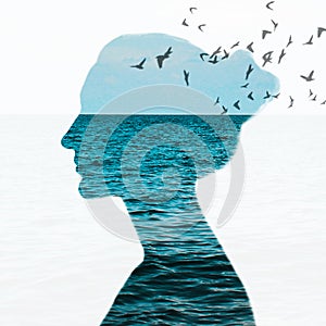Woman portrait with double exposure and with the blue sea and flying birds