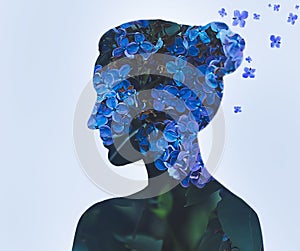 Woman portrait with double exposure and with flowers of blue lilac closeup