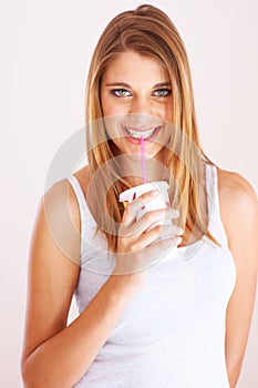 Woman, portrait and drink cup of soda, fizzy cola and ice cold milkshake in studio on white background. Thirsty, happy