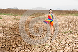 Woman portrait in dryland with drought ground texture. concept climate changed.