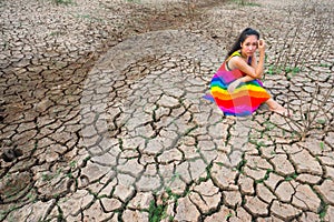 Woman portrait in dryland with drought ground texture. concept climate changed.