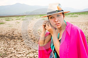 Woman portrait in dryland with drought ground texture. concept climate changed.