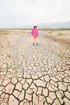 Woman portrait in dryland with drought ground texture. concept climate changed.