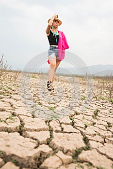 Woman portrait in dryland with drought ground texture. concept climate changed.