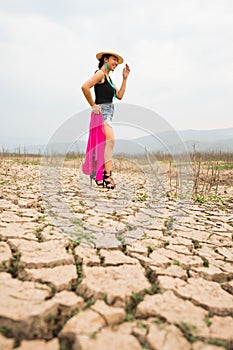 Woman portrait in dryland with drought ground texture. concept climate changed.