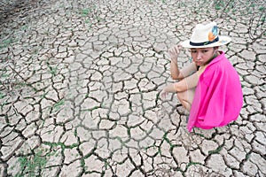 Woman portrait in dryland with drought ground texture. concept climate changed.