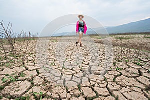 Woman portrait in dryland with drought ground texture. concept climate changed.