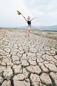 Woman portrait in dryland with drought ground texture. concept climate changed.