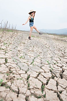 Woman portrait in dryland with drought ground texture. concept climate changed.