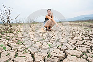 Woman portrait in dryland with drought ground texture. concept climate changed.