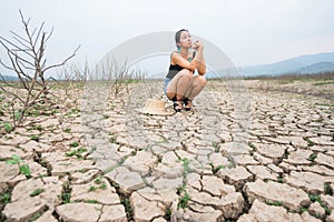 Woman portrait in dryland with drought ground texture. concept climate changed.